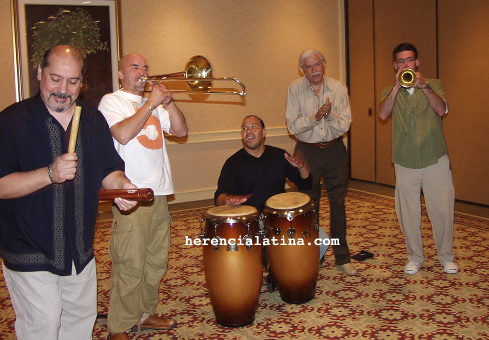 Left to right Ray de La Paz en claves, Jimmy Bosch con trombon, Bobby Allende en congas, Johnny Pacheco en ritmo aplaudiendo y John Walsh en trompeta